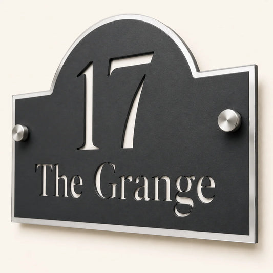 Close-up angled view of personalised black acrylic Arch house sign with mirror silver detailing