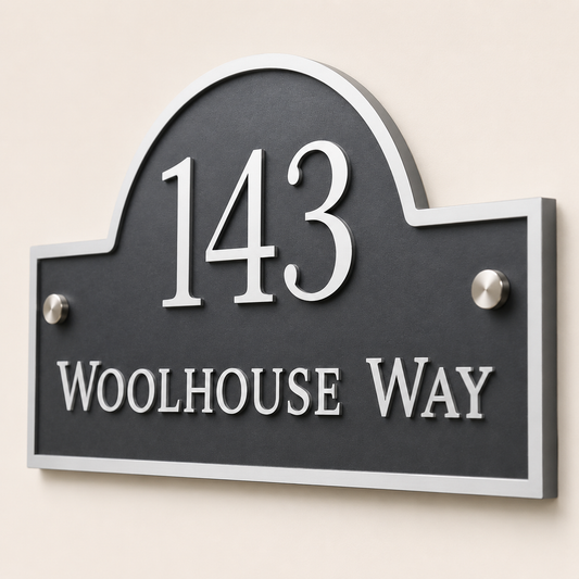 Close up of personalised mineral grey arch acrylic house sign showing raised white lettering and layered acrylic detail