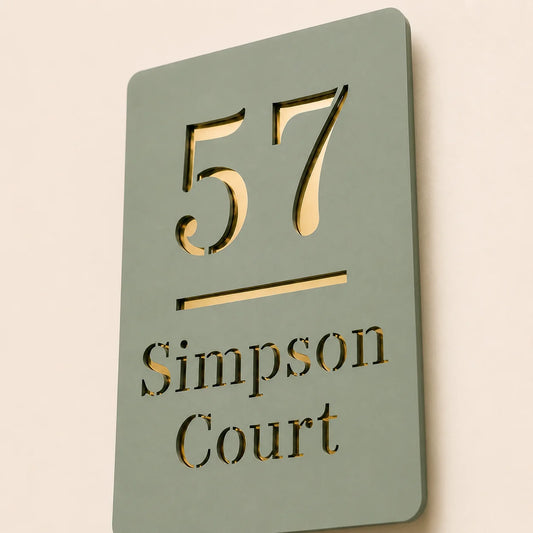Close-up angled view of personalised sage green acrylic house sign with mirror gold detailing