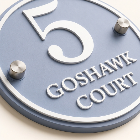 Close-up of dusky blue acrylic house sign with matt white raised lettering