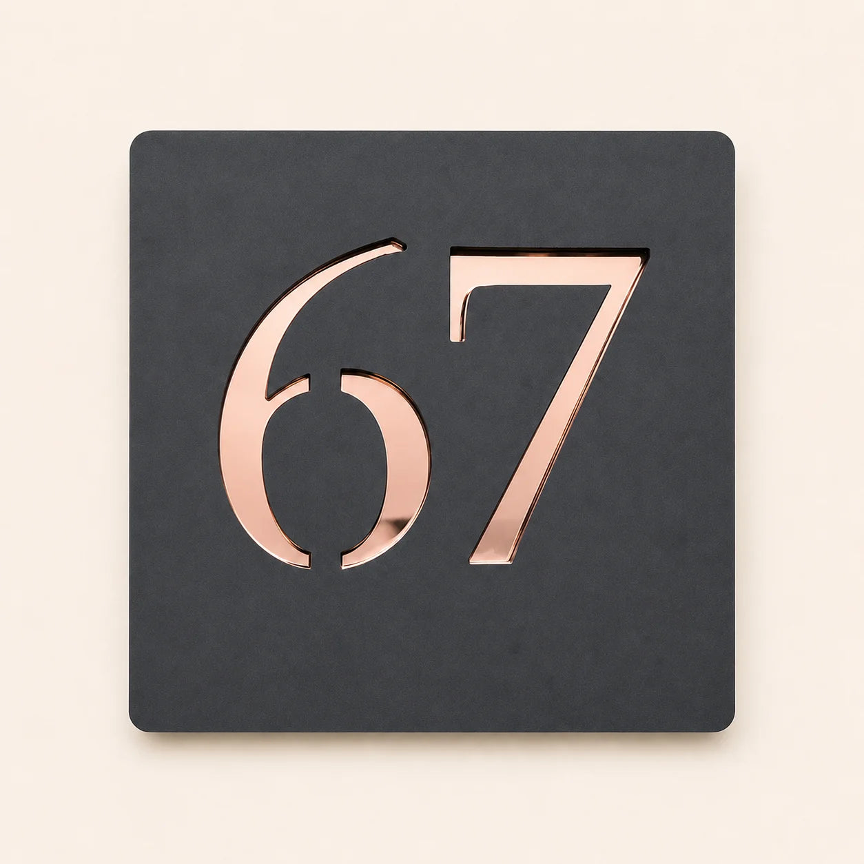 Personalised anthracite grey square acrylic house sign featuring raised rose gold mirror house number 67 with a modern minimalist design.
