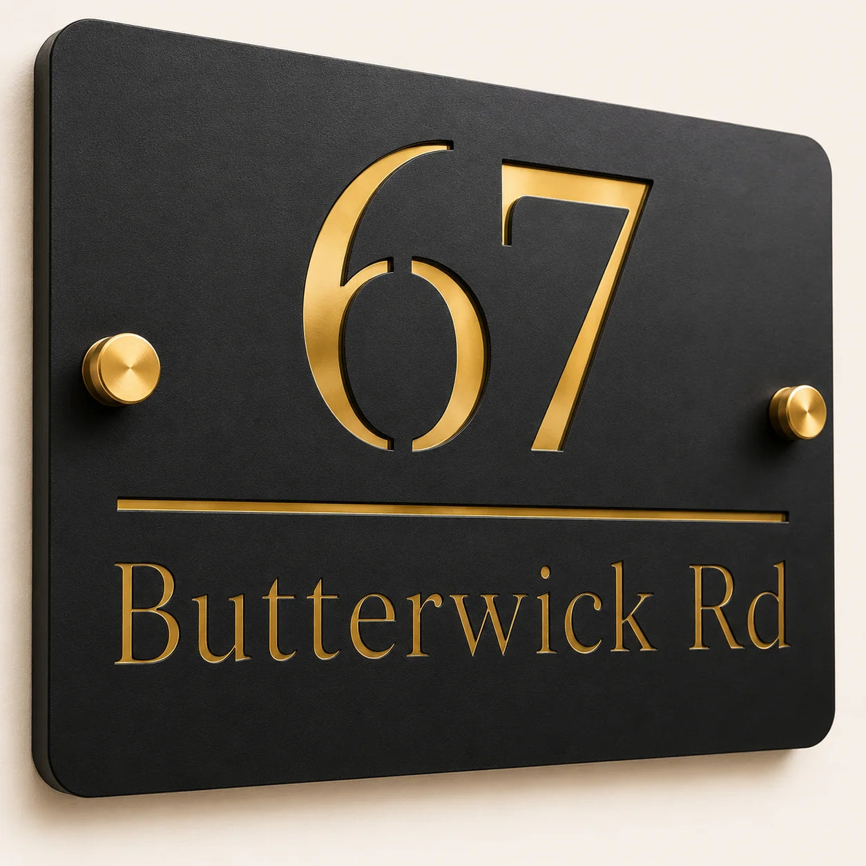Close-up angled view of personalised black rectangular acrylic house sign with mirror gold number and lettering