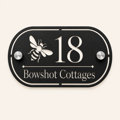 Personalised black oval acrylic house sign with mirror silver bee design, house number and house name