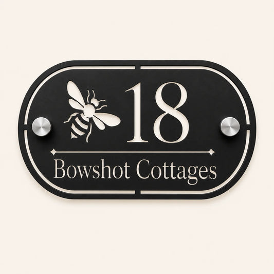 Personalised black oval acrylic house sign with mirror silver bee design, house number and house name