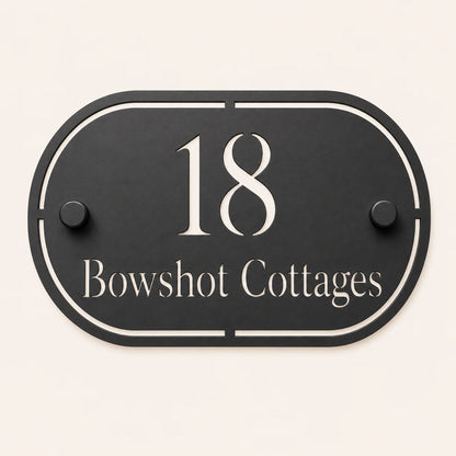 Personalised black oval acrylic house sign with mirror silver house number and house name