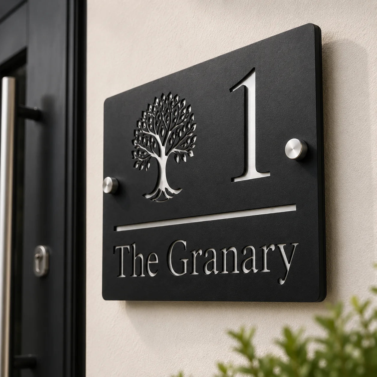 Close-up of personalised black rectangular acrylic house sign with mirror silver tree design mounted beside a front door