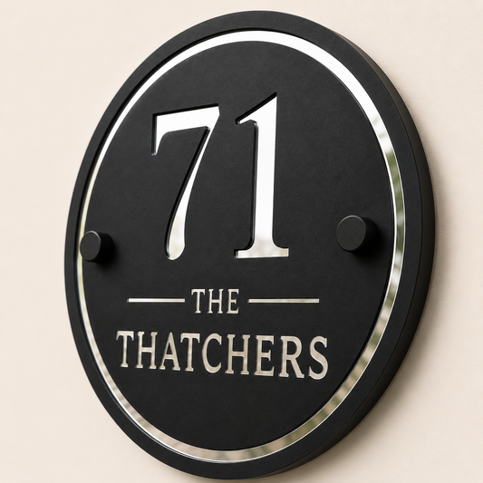 Close up of personalised black and mirror silver acrylic house sign showing layered detail