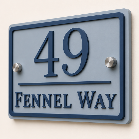 Close up of personalised dusky blue and denim blue acrylic house sign showing raised lettering and layered detail