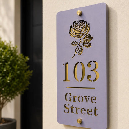 Close-up of personalised lavender vertical acrylic house sign with mirror gold rose detailing mounted beside a front door