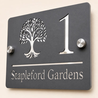 Close-up angled view of personalised mineral grey rectangular acrylic house sign with mirror silver tree design