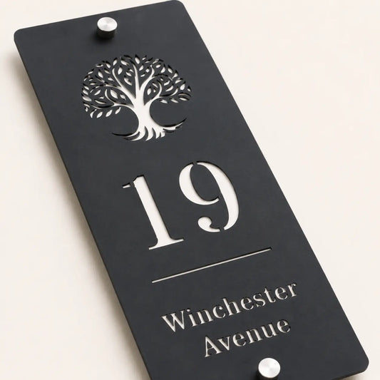 Close-up of personalised mineral grey house sign showing tree design and cut-out lettering