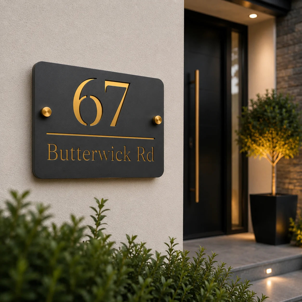 Personalised mineral grey acrylic house sign with gold mirror house number and address mounted beside a modern front door, creating a stylish contemporary entrance.
