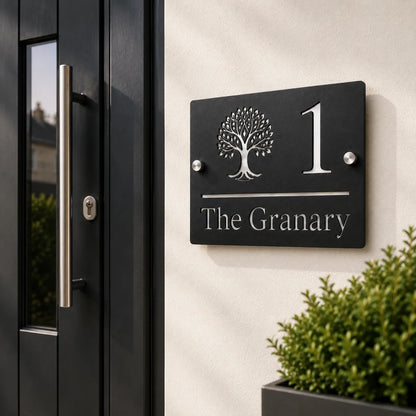Personalised black rectangular acrylic house sign with mirror silver tree design mounted beside a modern front door