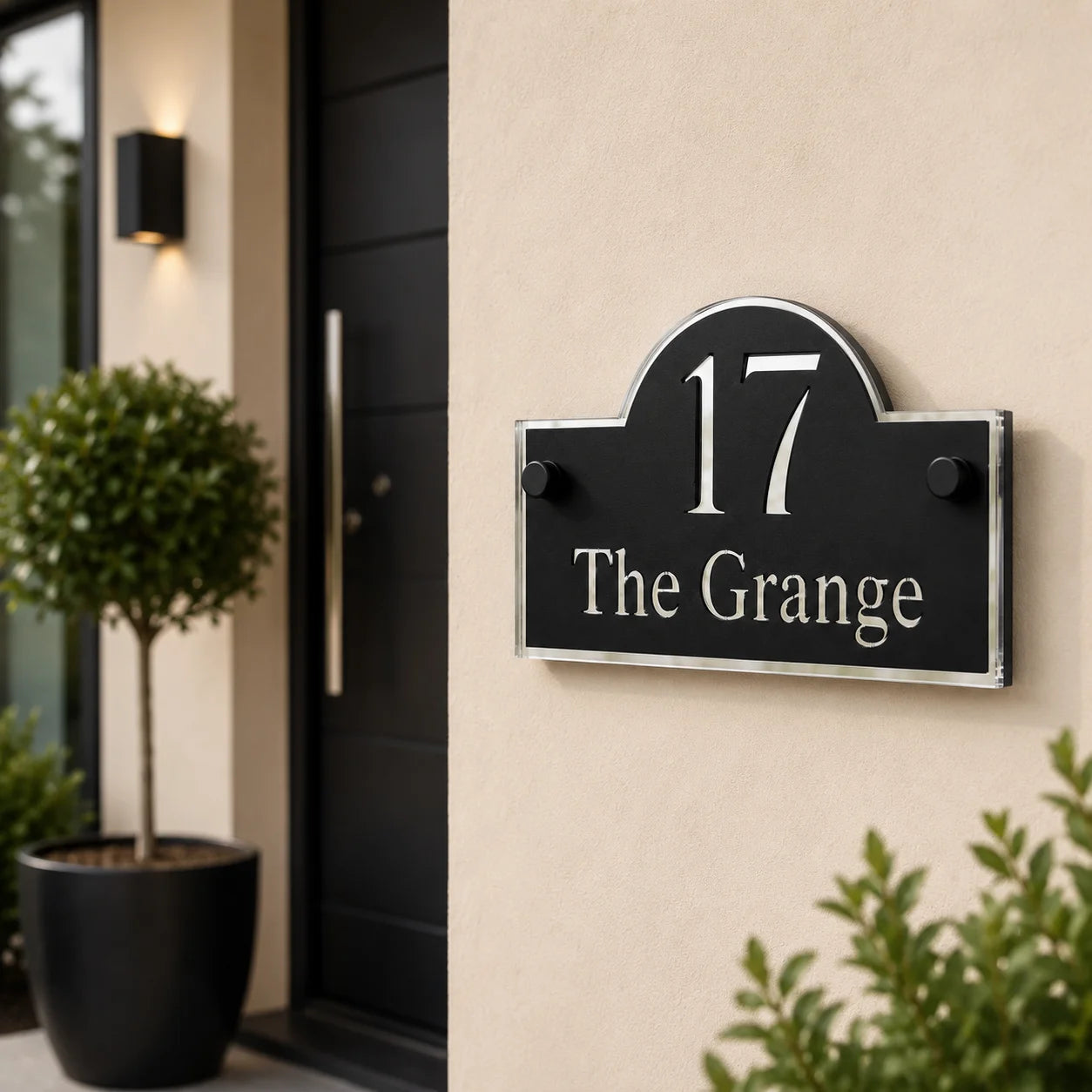 Personalised black & Silver arch acrylic house sign with mirror silver detailing mounted beside a modern front door