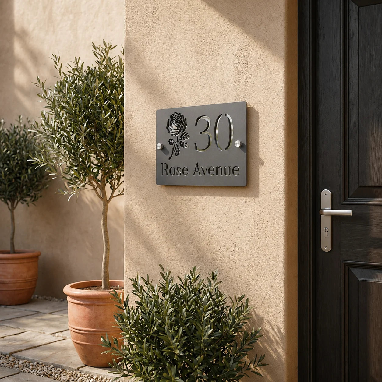 Personalised mineral grey rectangular acrylic house sign with mirror silver rose design mounted beside a front door