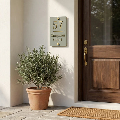 Personalised sage green and mirror gold acrylic house sign mounted beside a wooden front door