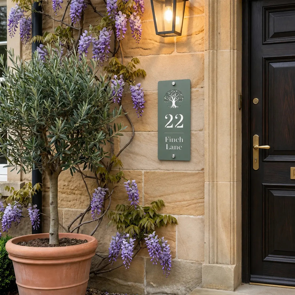 Personalised sage green tree house sign mounted beside a front door on a stone wall