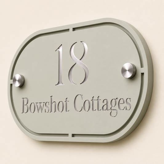 Close up of personalised sage green and mirror silver  oval acrylic house sign showing layered detail