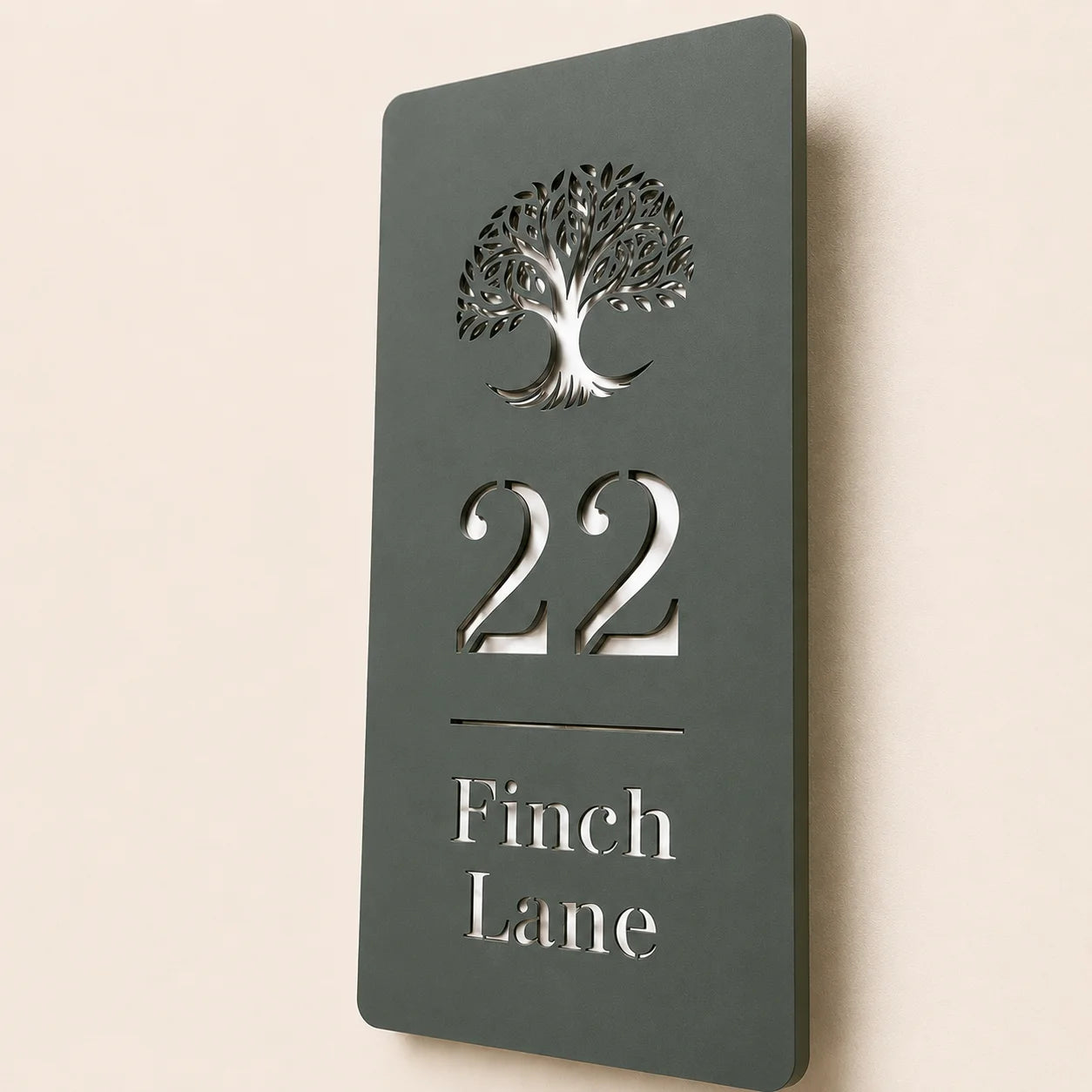 Close-up angled view of personalised pine green acrylic house sign with mirror silver detailing