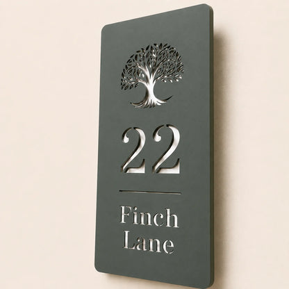 Close-up angled view of personalised pine green acrylic house sign with mirror silver detailing