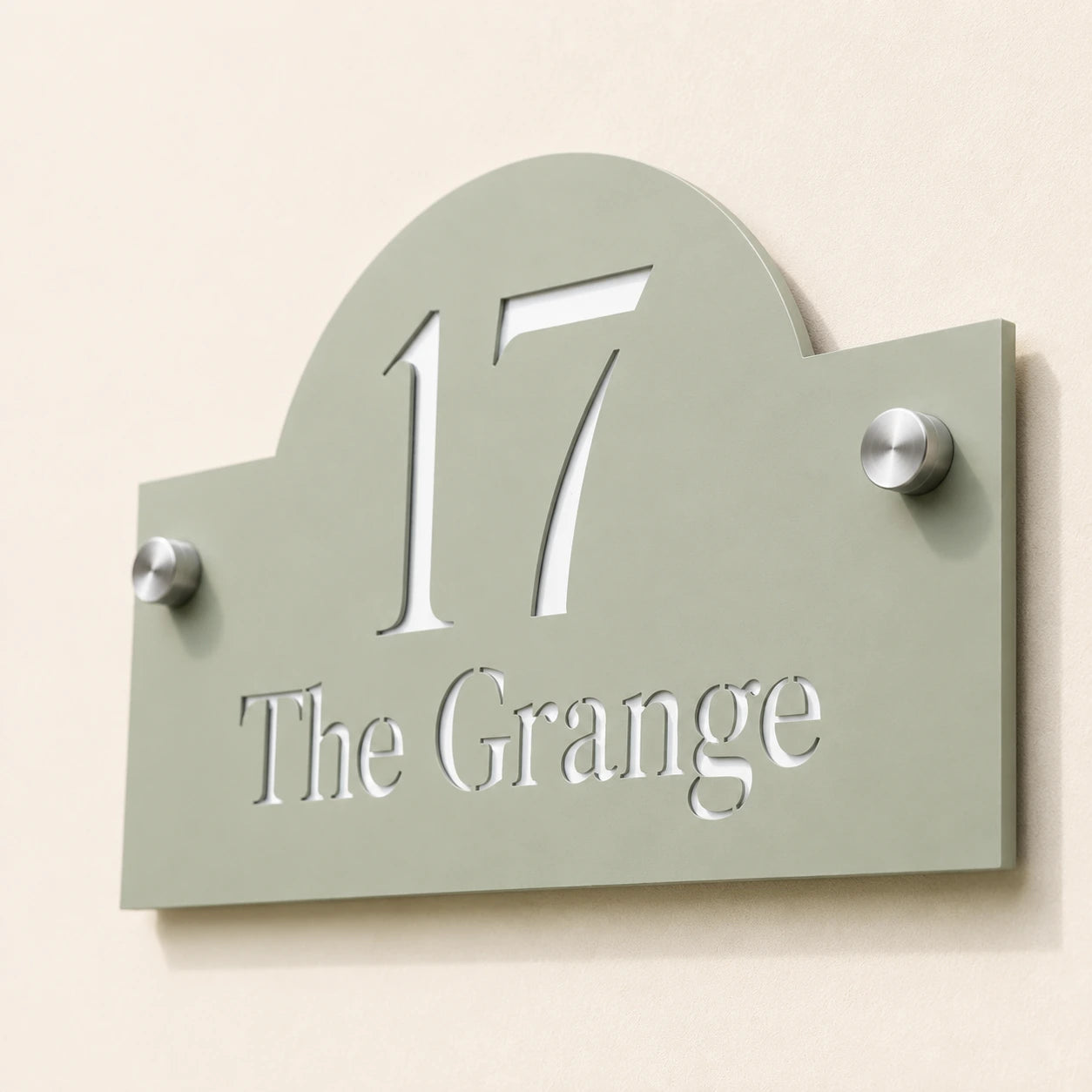 Close-up of personalised sage green arch acrylic house sign showing cut-out number and address details
