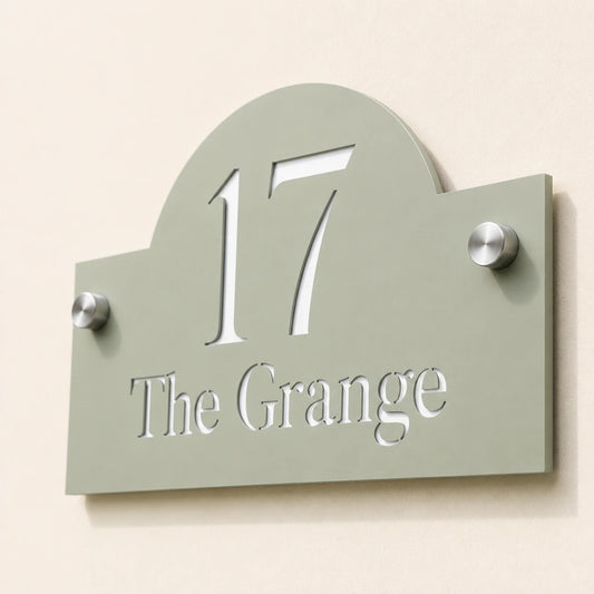 Close-up of personalised sage green arch acrylic house sign showing cut-out number and address details