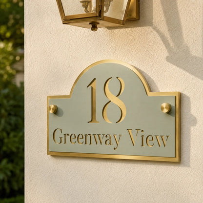 Close-up of personalised sage green and mirror gold acrylic house sign mounted on an exterior wall