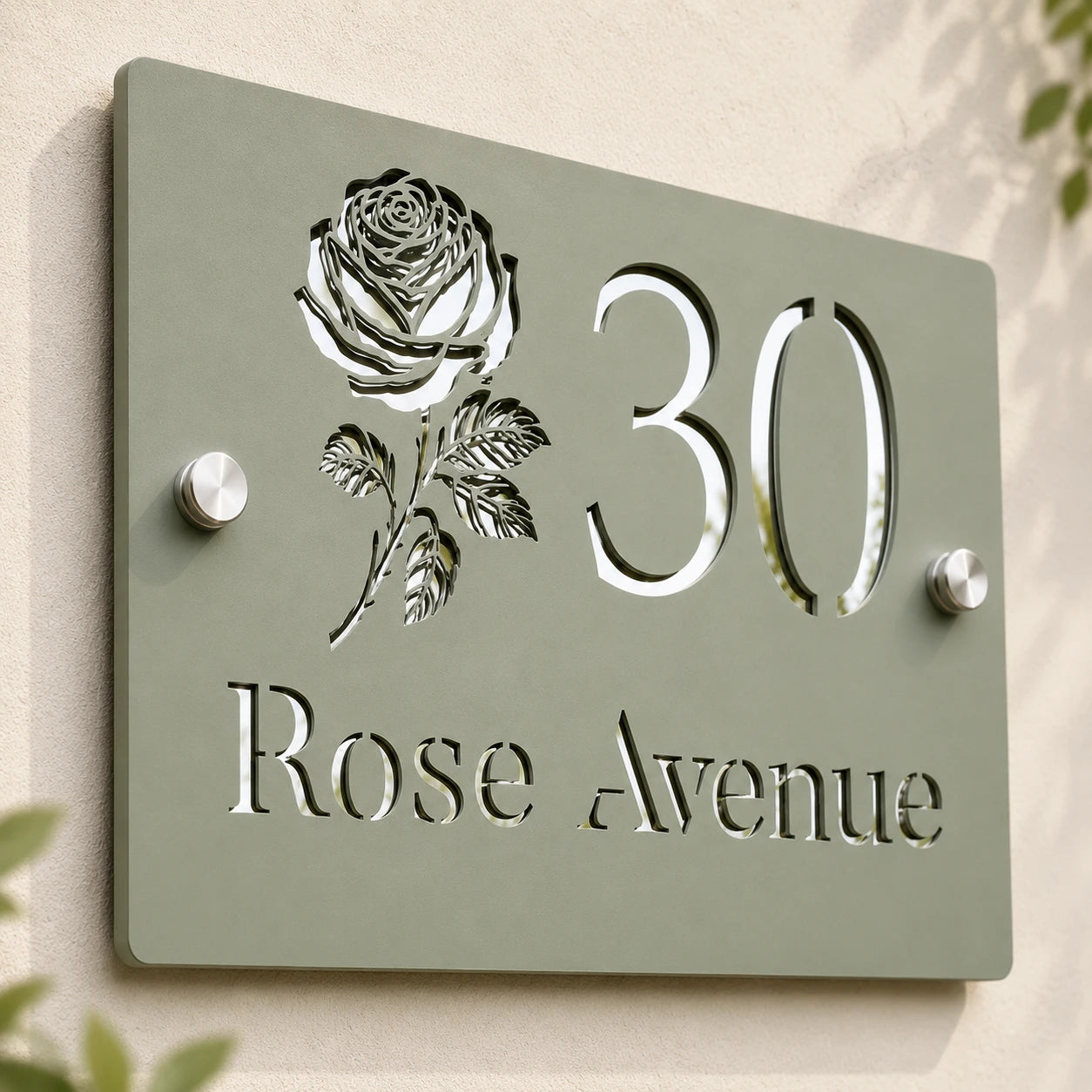 Close-up of personalised sage green acrylic house sign showing mirror silver rose, number and address details