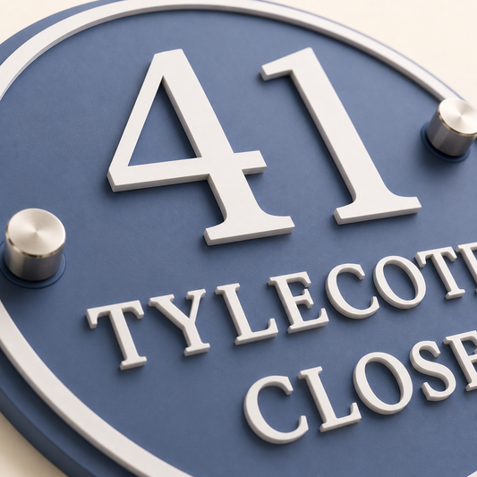 Close-up of personalised denim blue acrylic house sign with raised white lettering